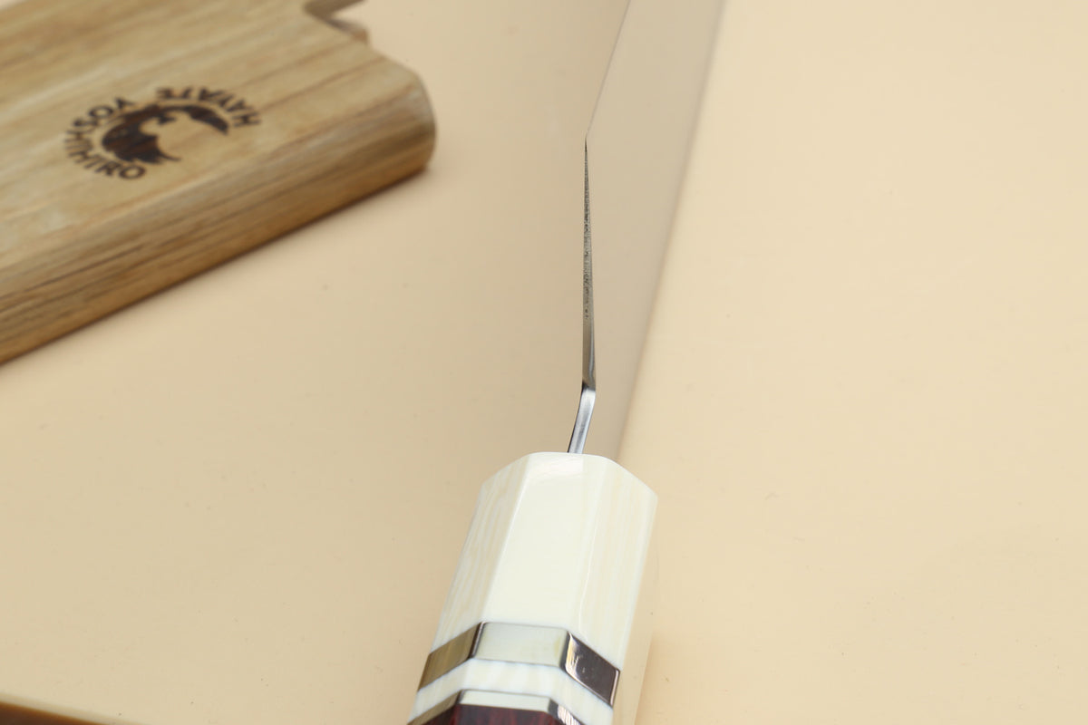 Chef knife bolster close-up with ivory grip and rosewood handle