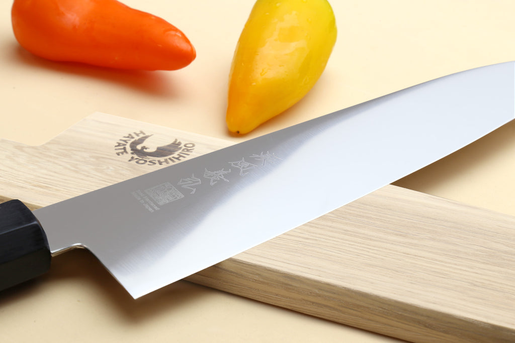 Japanese chef knife with ice-hardened stainless blade and Shitan rosewood handle, side view