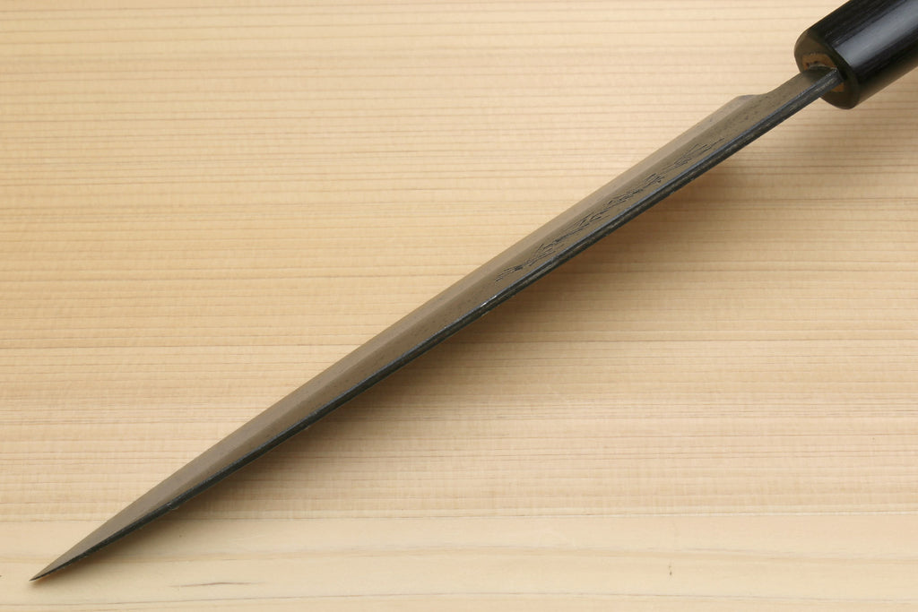 Petty knife side view with blue steel blade and dark wood handle