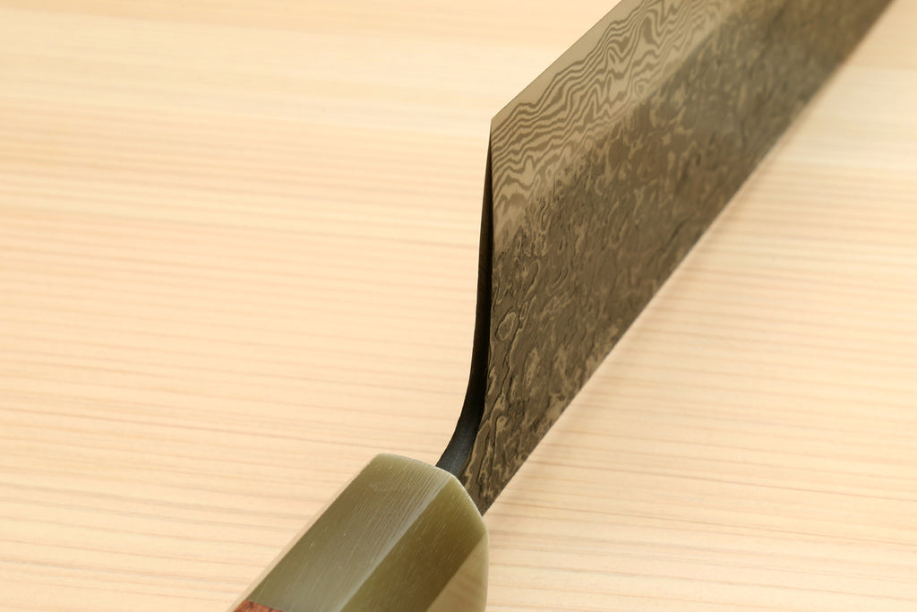 Nakiri blade edge view with dark damascus pattern and ironwood handle