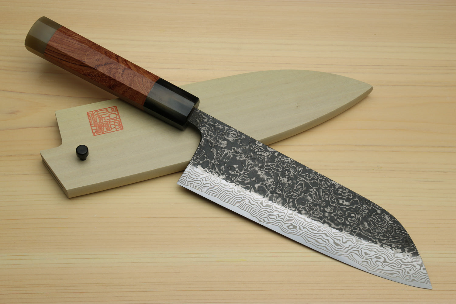 Damascus santoku chef knife with ironwood handle, blade facing right