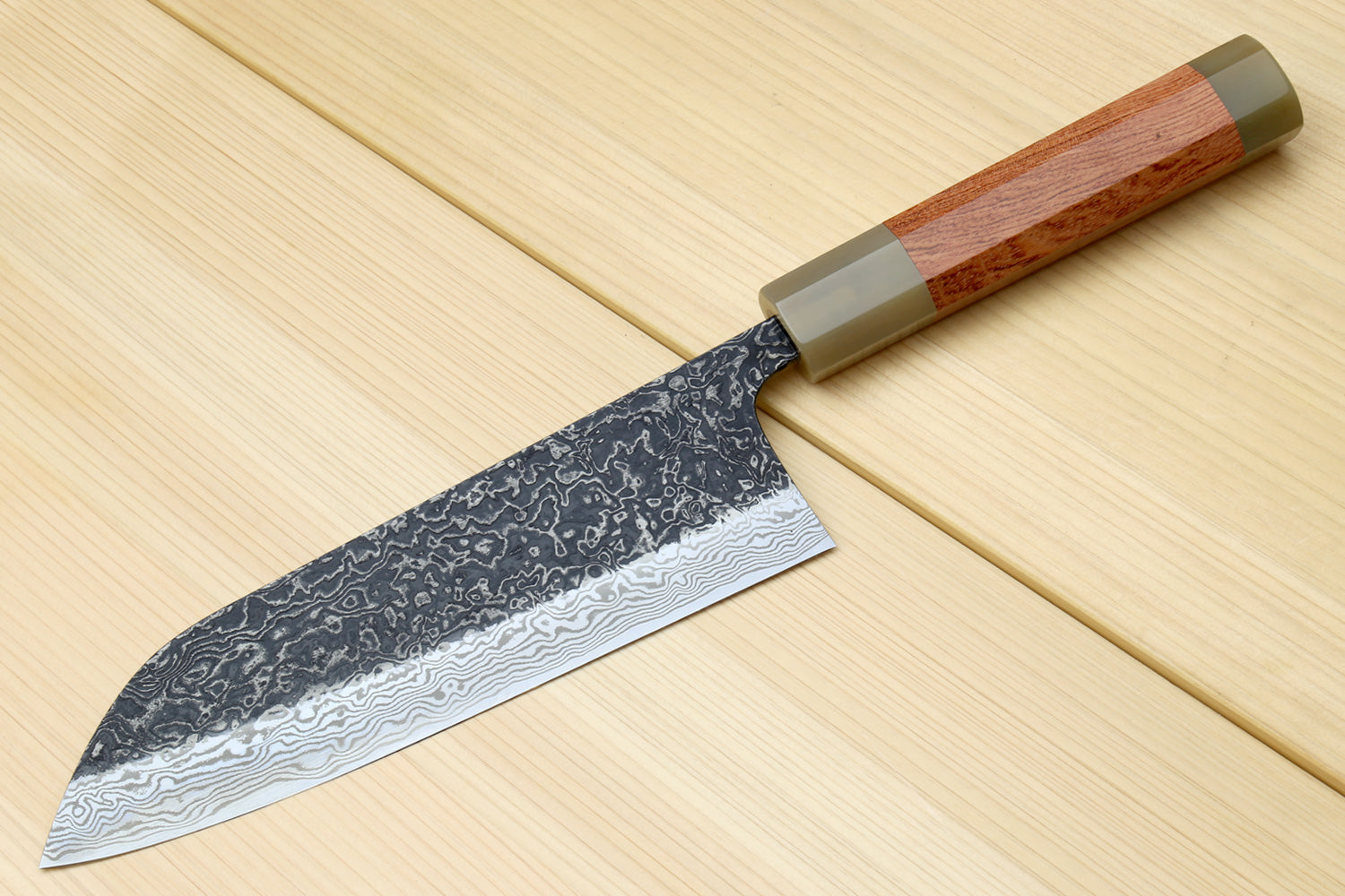 Damascus santoku chef knife with ironwood handle and dark patterned blade