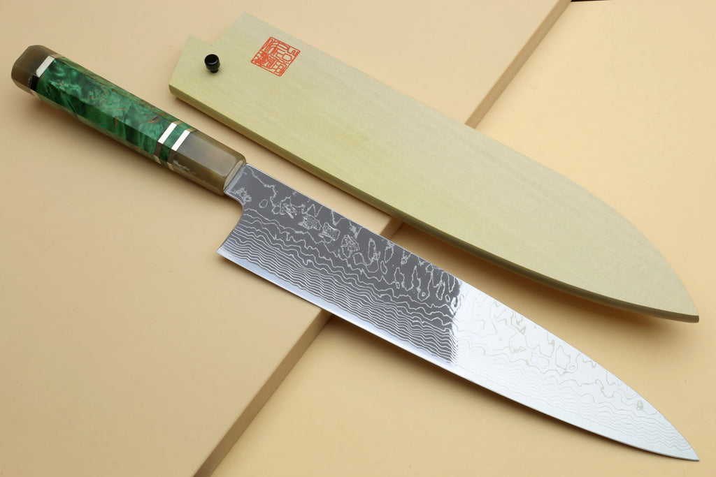 Damascus gyuto chef knife with dark green handle and wavy Damascus blade, tip view