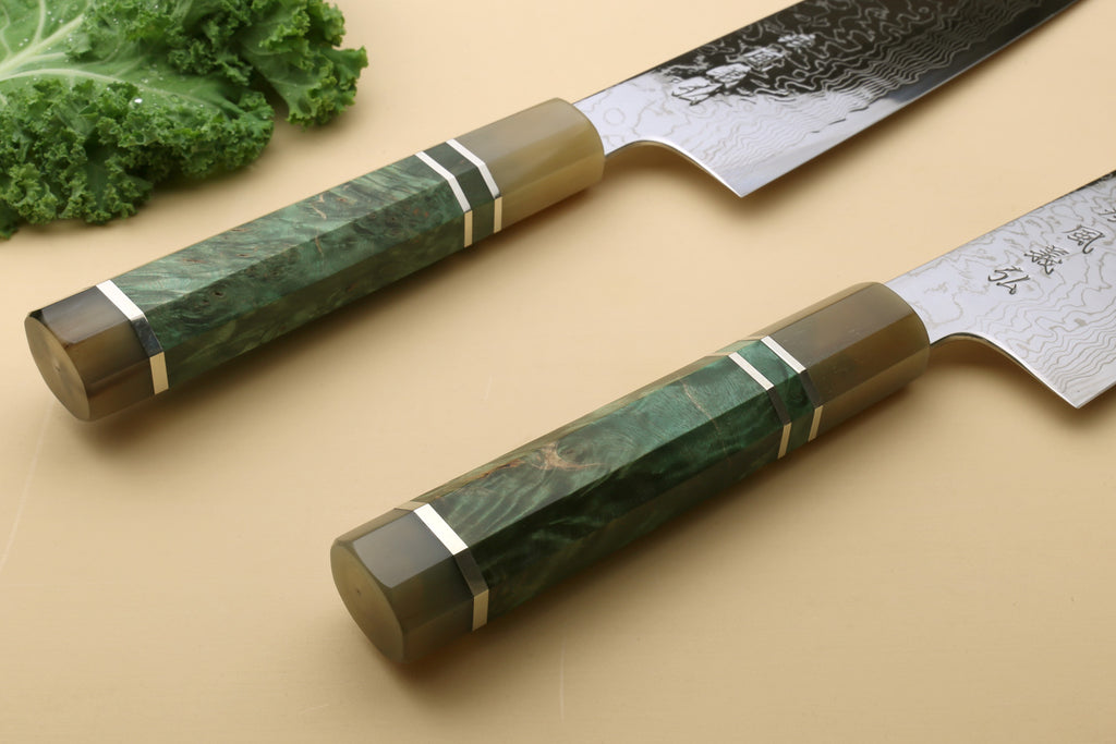 Pair of Damascus gyuto chef knives with dark green handles and patterned blades