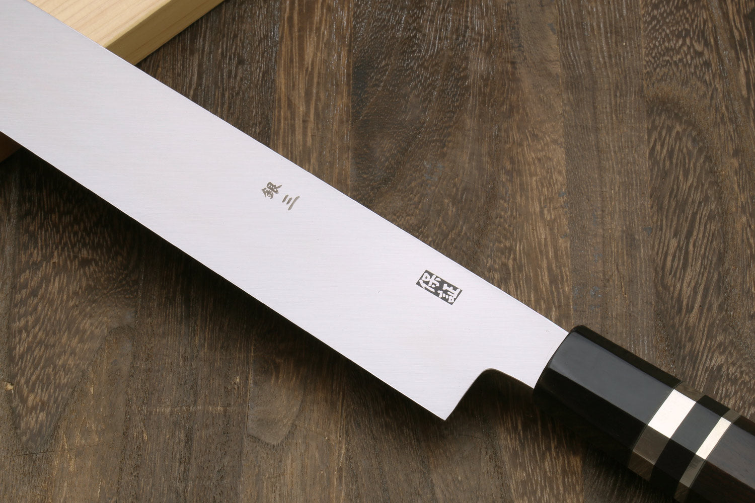 Tuna knife blade detail with engraving and ebony handle with silver ring accents