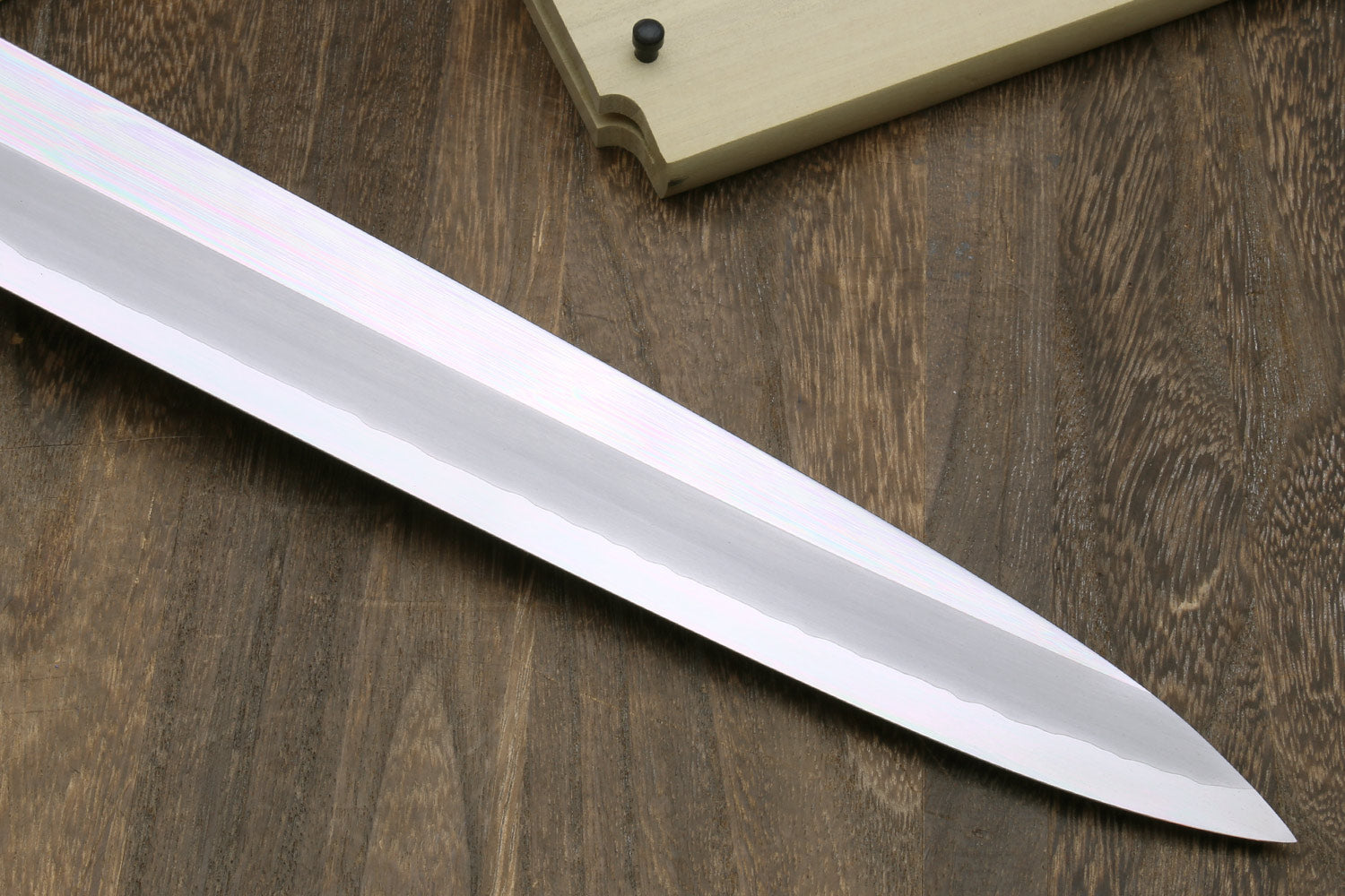 Tuna knife blade close-up with mirror finish and pointed tip