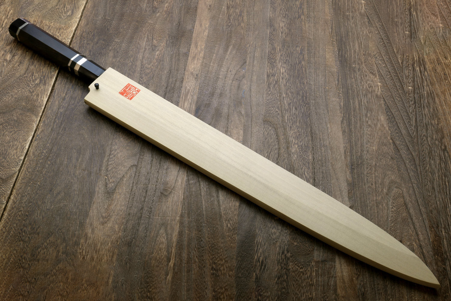 Yanagi-style tuna knife with long mirror-polished steel blade and ebony handle with rings
