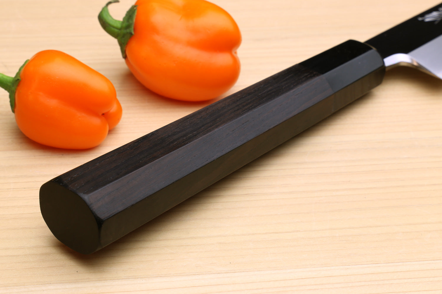 Yanagi kiritsuke knife with dark handle and mirror-polished blade