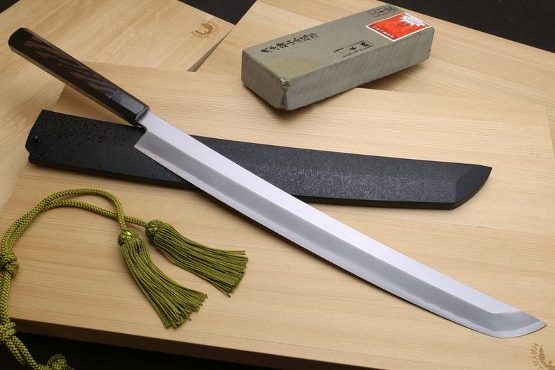 Tuna knife with long silver blade, black sheath, green tassel cord, and box