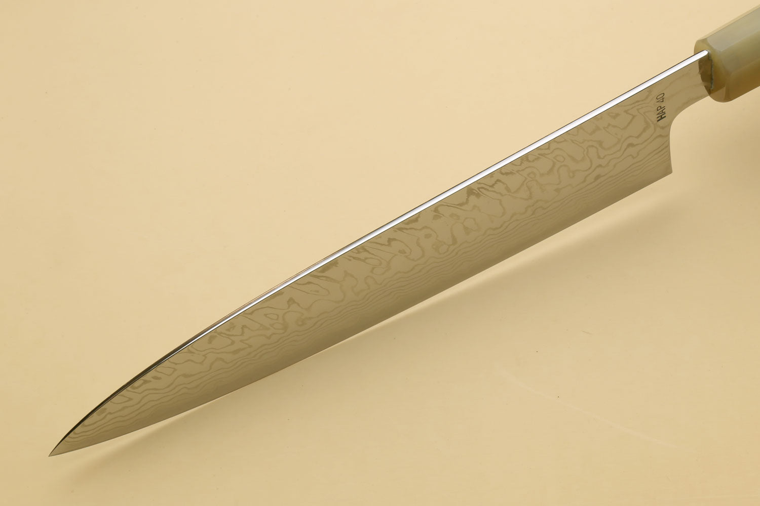 Damascus gyuto chef knife blade side view with wavy Damascus pattern
