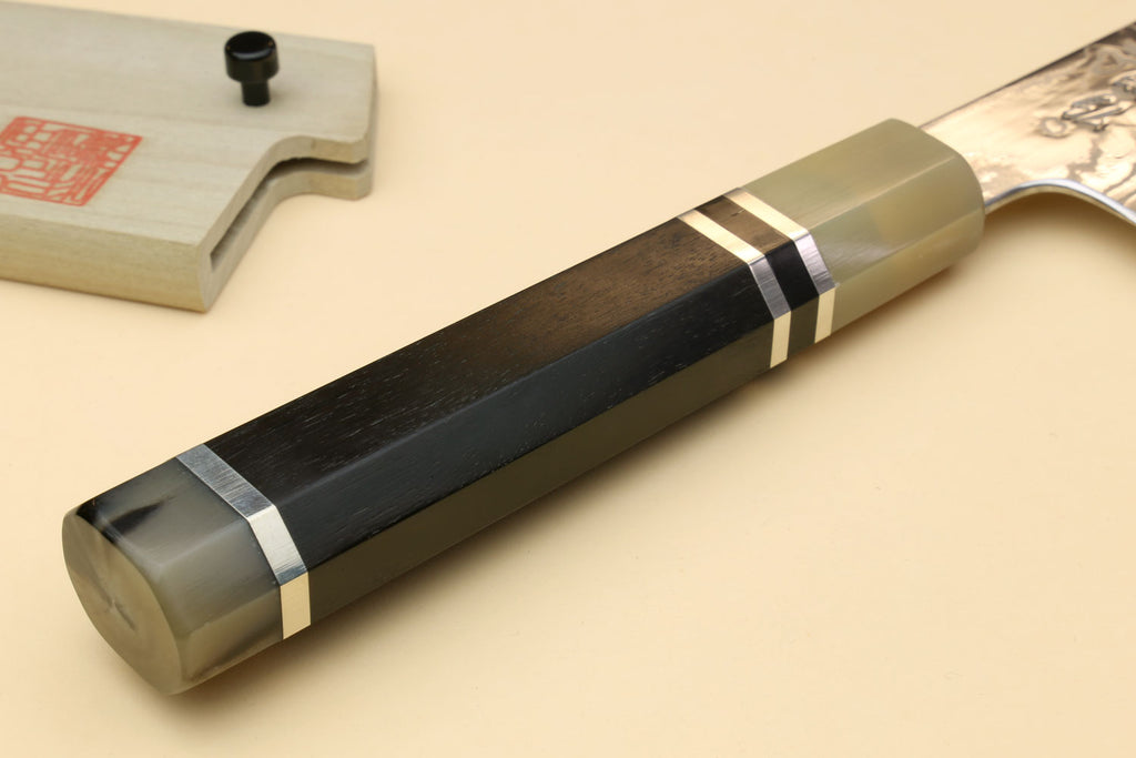 Damascus gyuto chef knife with octagonal ebony handle, triple-ring bolster, top view