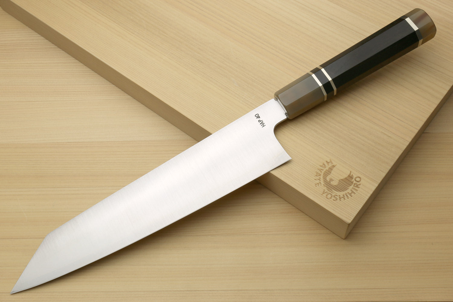 Kiritsuke chef knife with white steel blade and dark ebony handle, side view