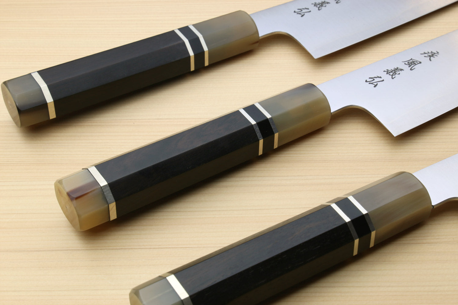 Set of three Kiritsuke chef knives with ebony handles and stainless blades