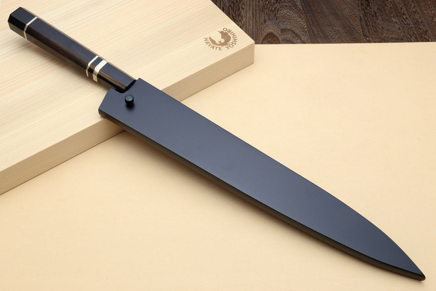 Sujihiki slicer knife with long dark blade, black handle, and triple nickel ring