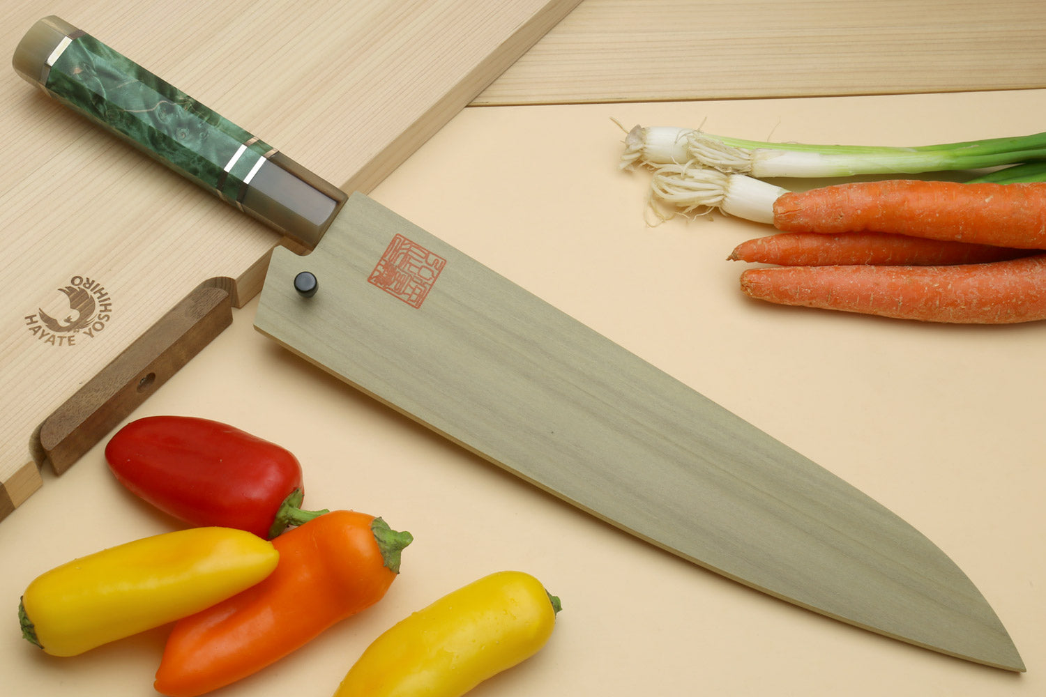 Chef's gyuto knife with green burl handle and Damascus-pattern blade