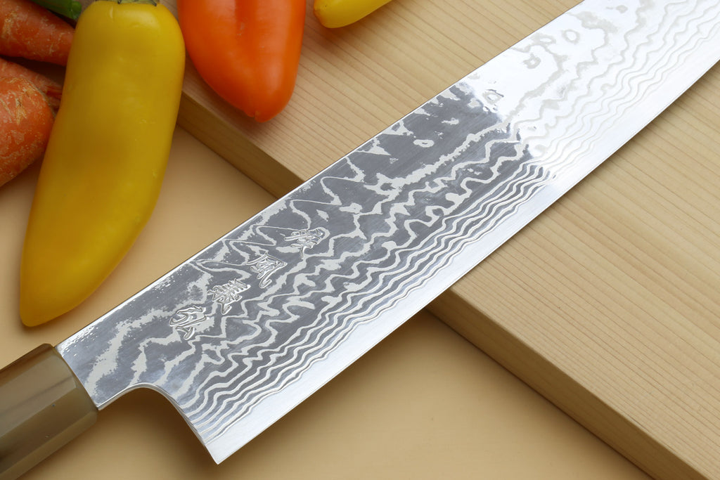 Yoshihiro HAP40 damascus kiritsuke knife blade closeup with white-gray pattern