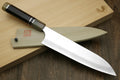 Gyuto chef knife with white stainless blade and ebony handle, triple ring accents