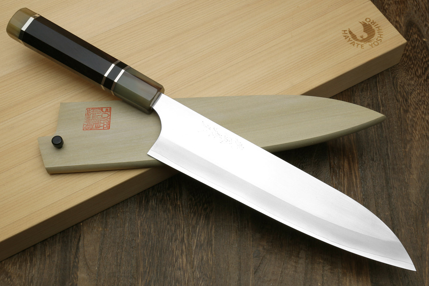 Gyuto chef knife with white stainless blade and ebony handle, triple ring accents