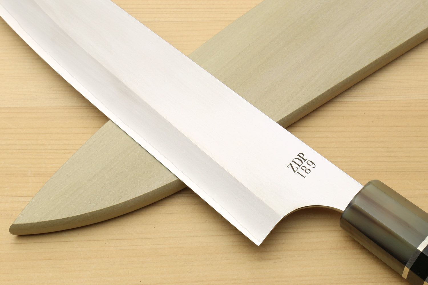 Gyuto chef knife with arched blade tip and ZDP-189 engraving on stainless steel