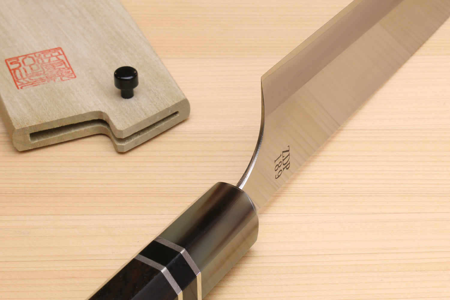 Gyuto chef knife close-up of spine and ebony handle ferrule with ring detail