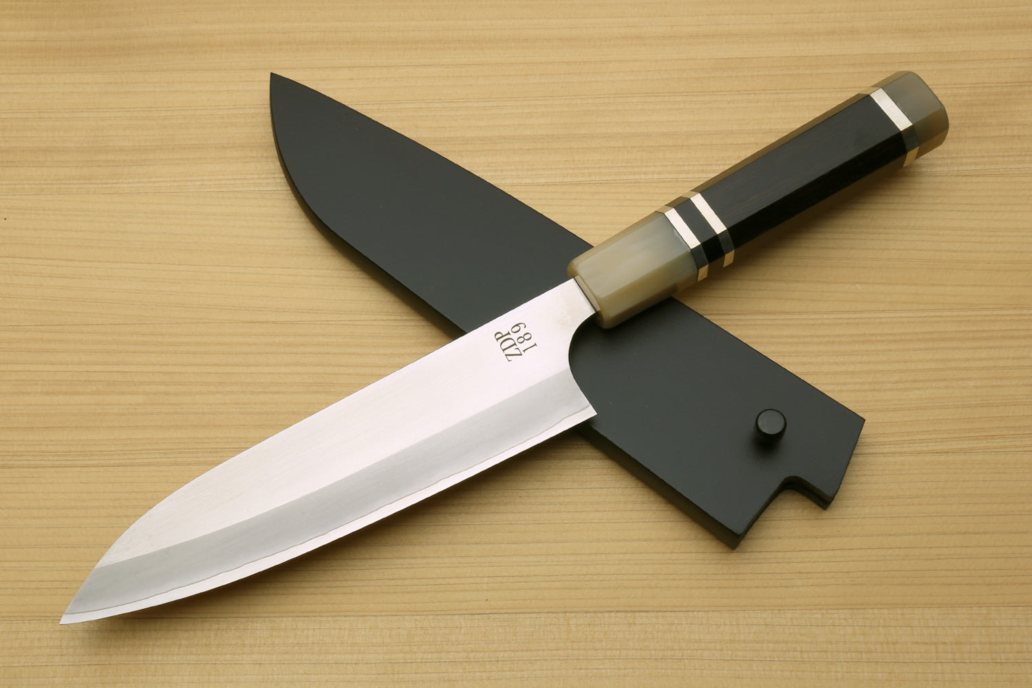 6-inch petty utility chef knife with stainless blade, dark handle, black blade guard