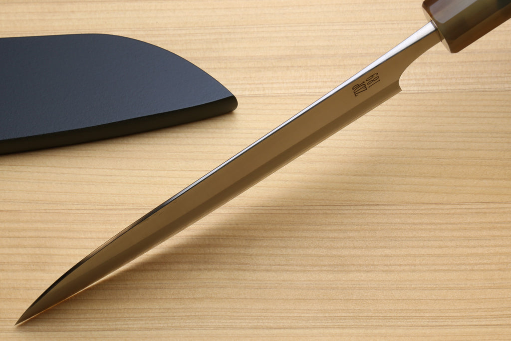 Petty utility chef knife side view with stainless blade and dark handle