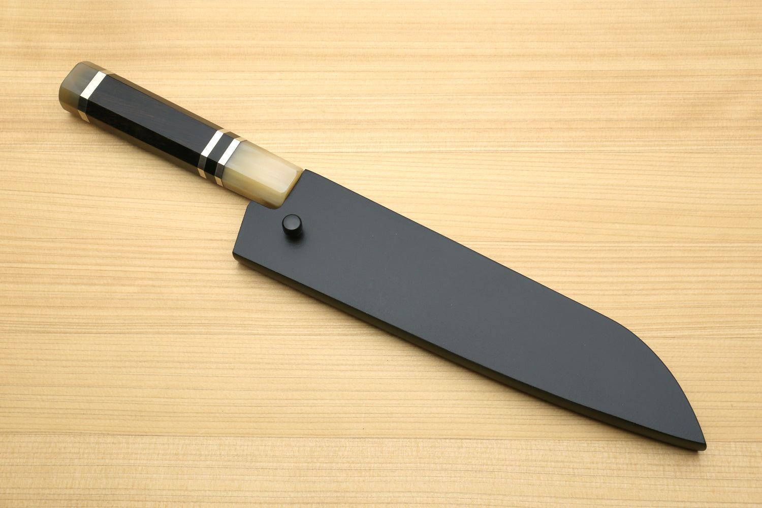 Petty utility chef knife with dark handle, stainless blade and black guard plate