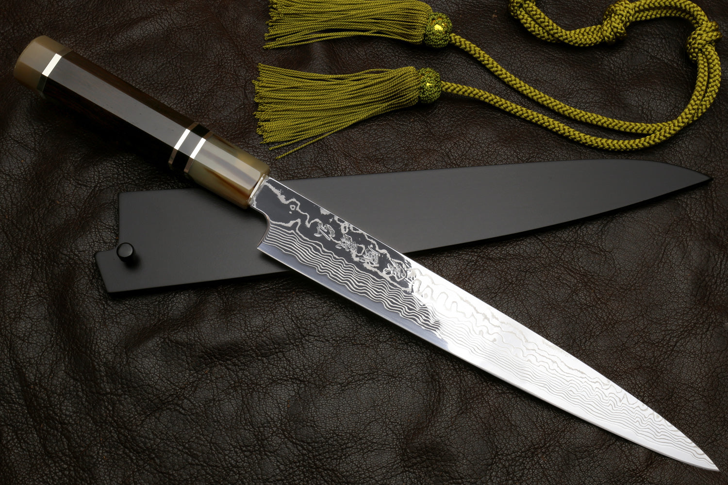 Sujihiki slicer knife with damascus blade and triple-ring handle, paired with tassel cord