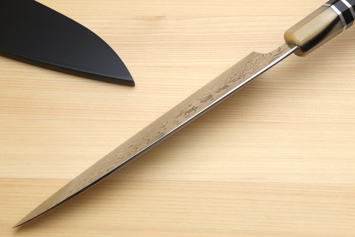 Damascus gyuto chef knife with octagonal dark handle and triple ring