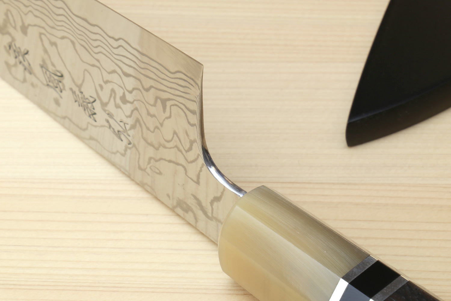 Damascus gyuto blade and octagonal handle detail with triple ring