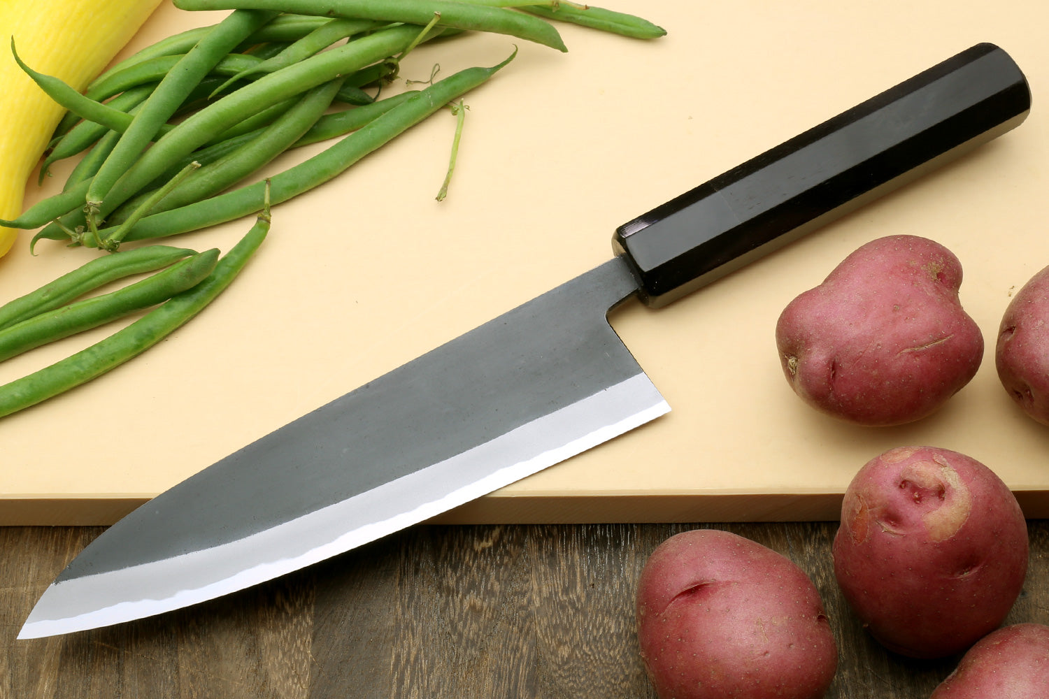 Japanese gyuto chef’s knife with dark kurouchi blade and ebony handle