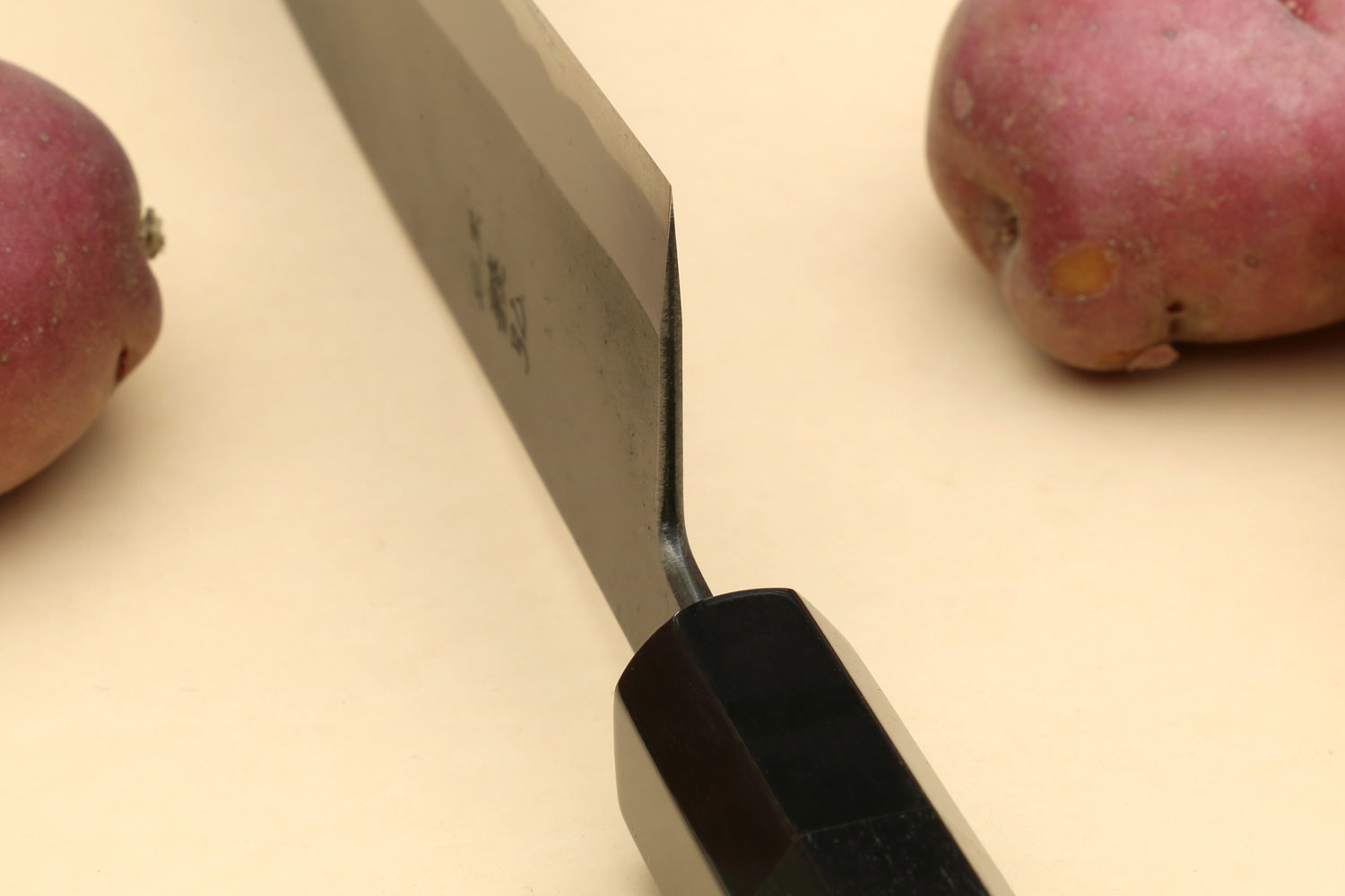 Japanese gyuto knife close-up of spine and ebony handle