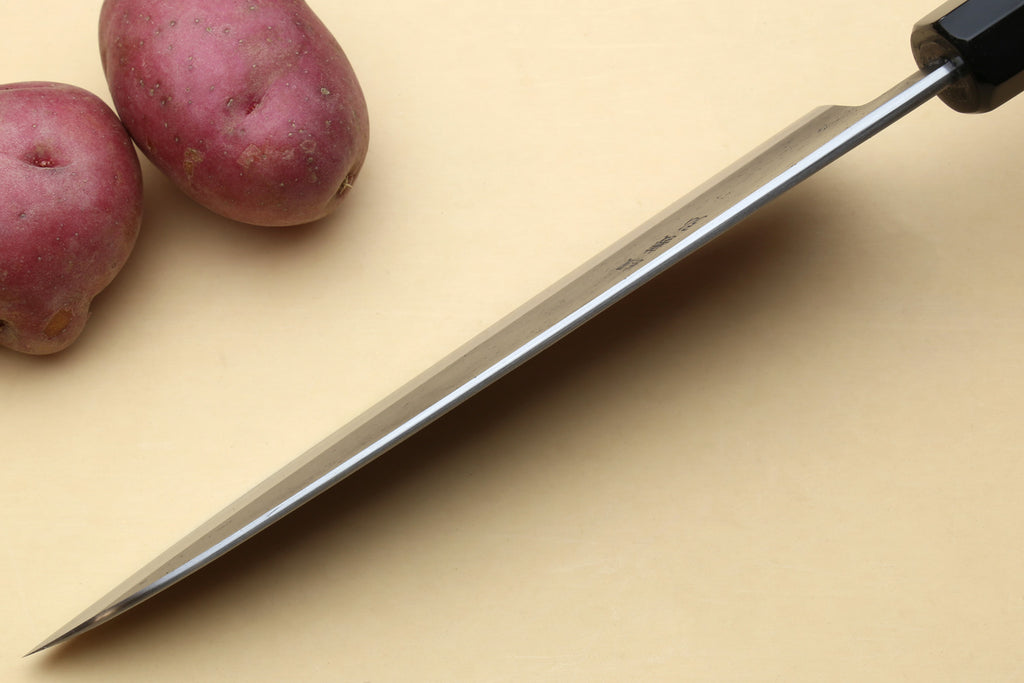Japanese gyuto chef’s knife with long stainless blade and black handle