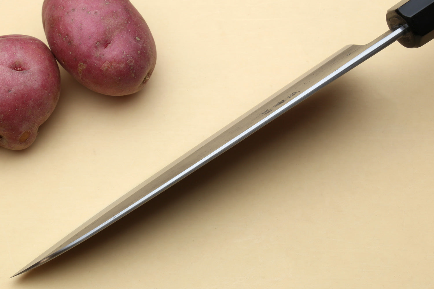 Japanese gyuto chef’s knife with long stainless blade and black handle
