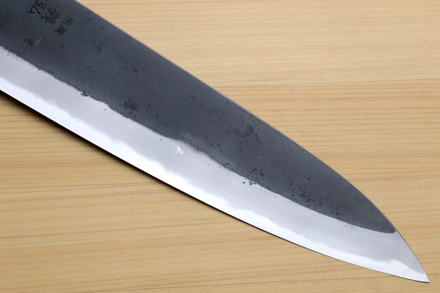 Kurouchi-finished blue steel gyuto blade with sharp point and plain cutting edge