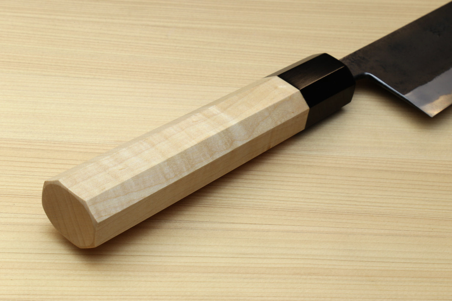 Kaede wooden handle with black collar and part of blue steel kurouchi gyuto blade