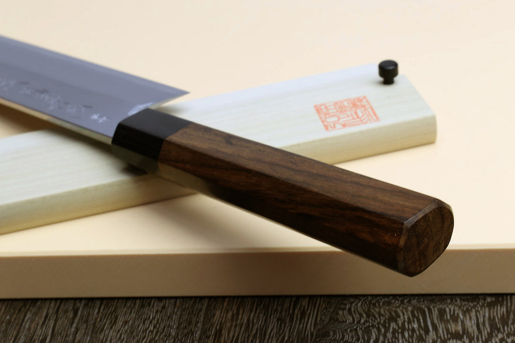 Japanese vegetable cleaver knife, blue steel blade with rosewood handle on light saya