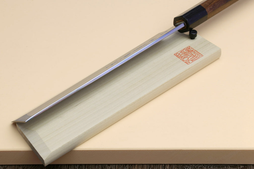 Japanese vegetable cleaver knife with blue steel blade and rosewood handle on light saya
