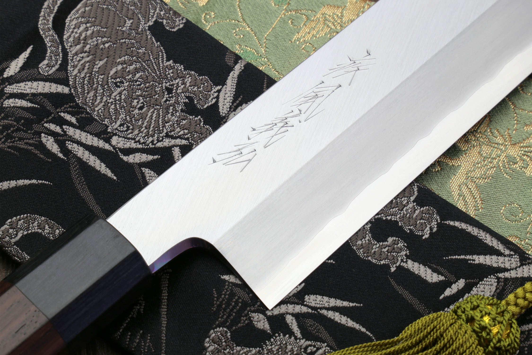 Japanese kama usuba knife with light blade and dark shitan handle, engraved detail.