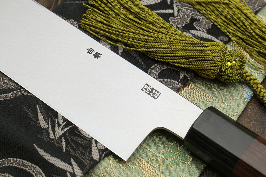 Japanese kama usuba knife heel view with light blade, dark handle, and stamps.