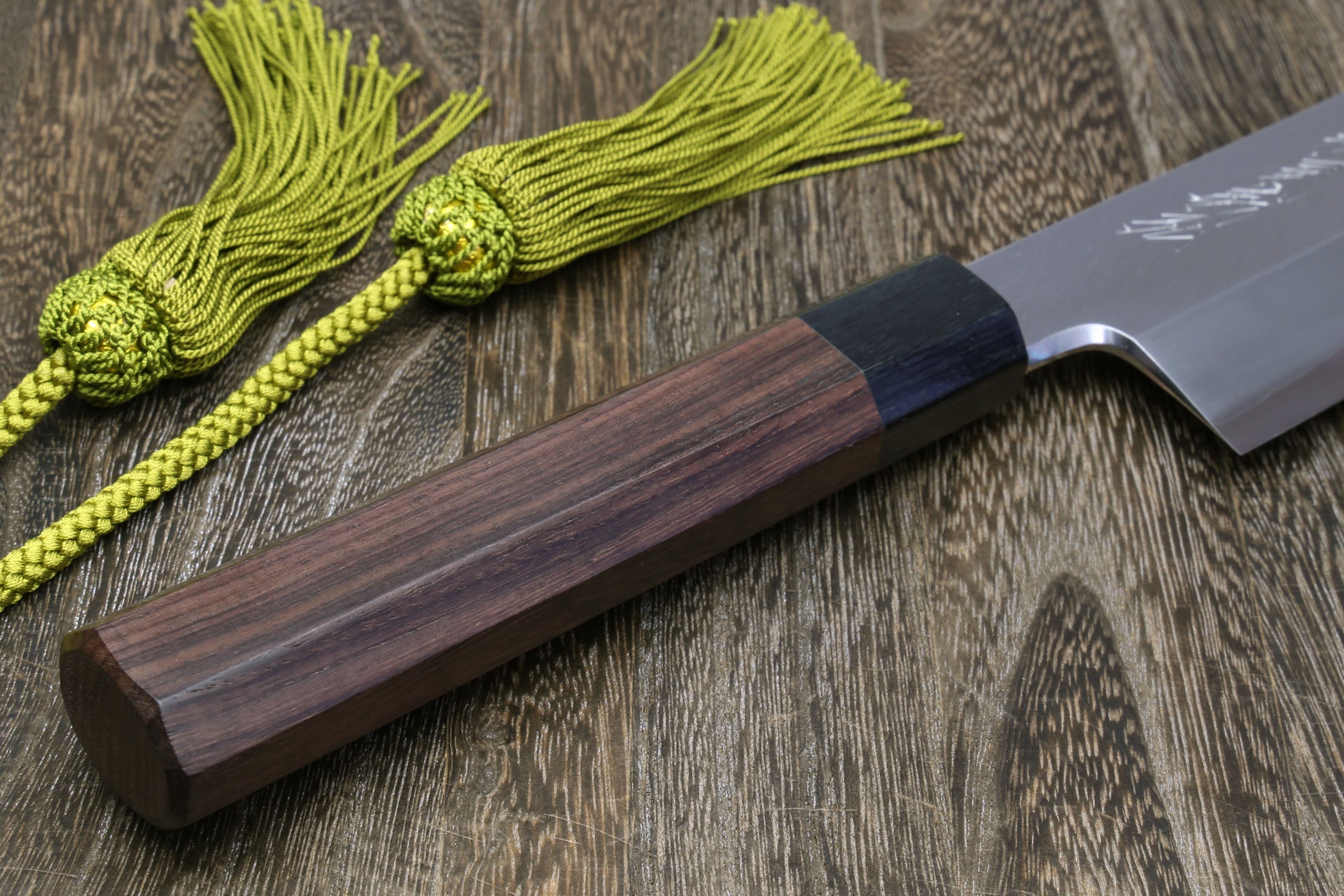Japanese kama usuba knife with dark shitan handle and light blade, shown with cord.