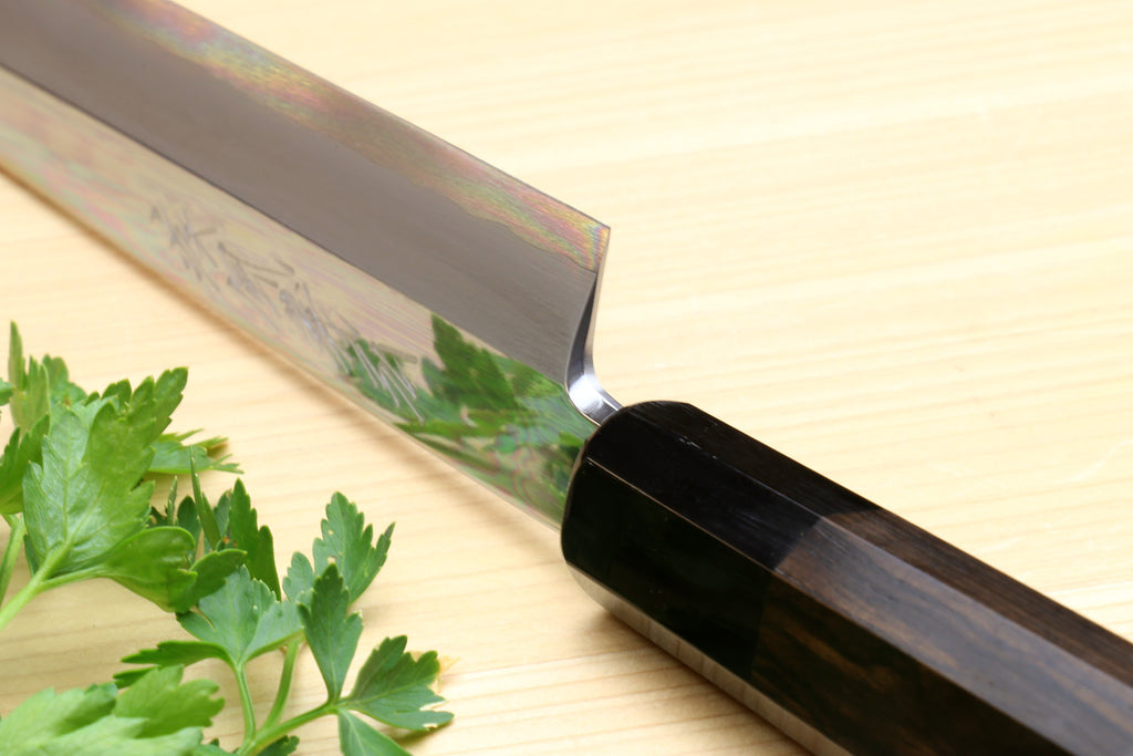 Yanagi sashimi knife close-up of mirror-polished blade and ebony handle