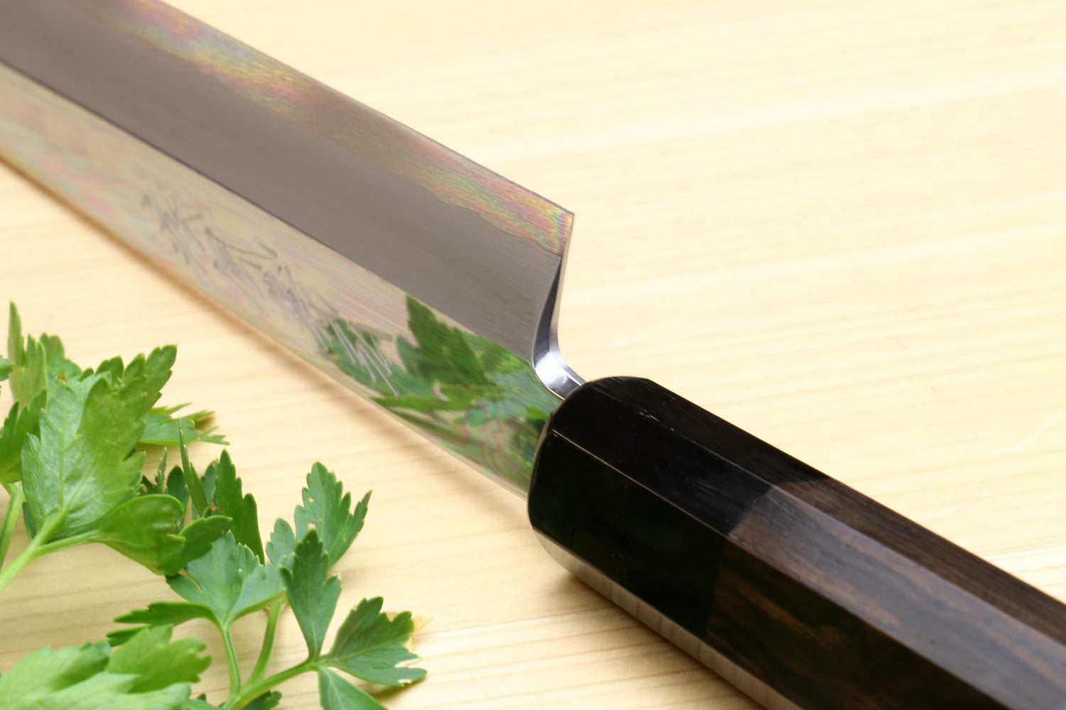 Yanagi sashimi knife close-up of mirror-polished blade and ebony handle