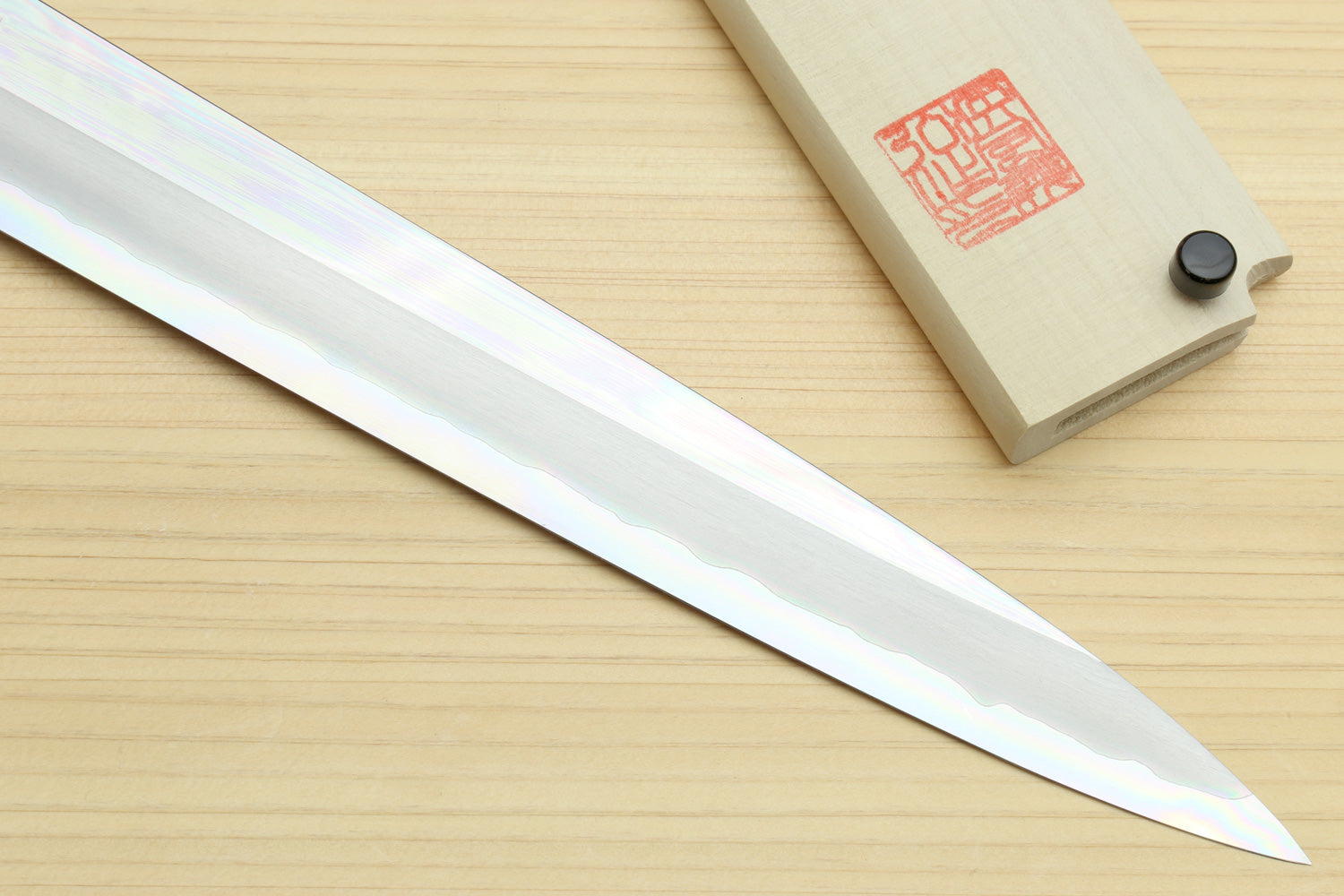 Yanagi sashimi knife close-up of polished blade and ebony handle