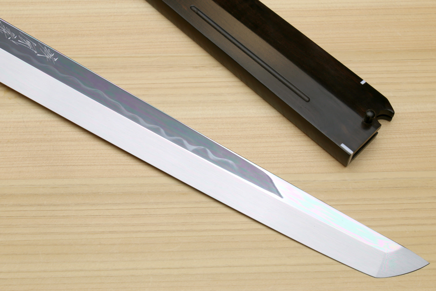 Japanese sushi knife blade with mirror-finished white steel and subtle wave pattern