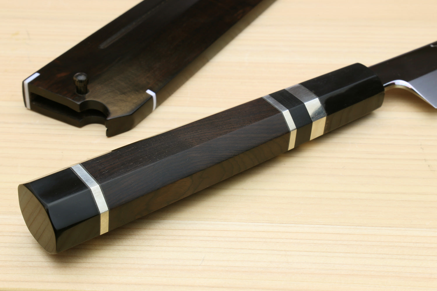 Japanese sushi knife handle with striped ring accents, in ebony saya