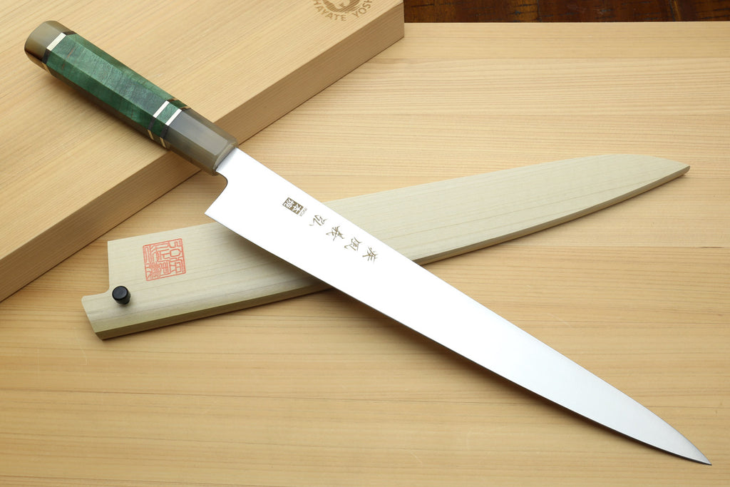 Sujihiki slicer knife with white blade, dark green handle, and wooden saya sheath