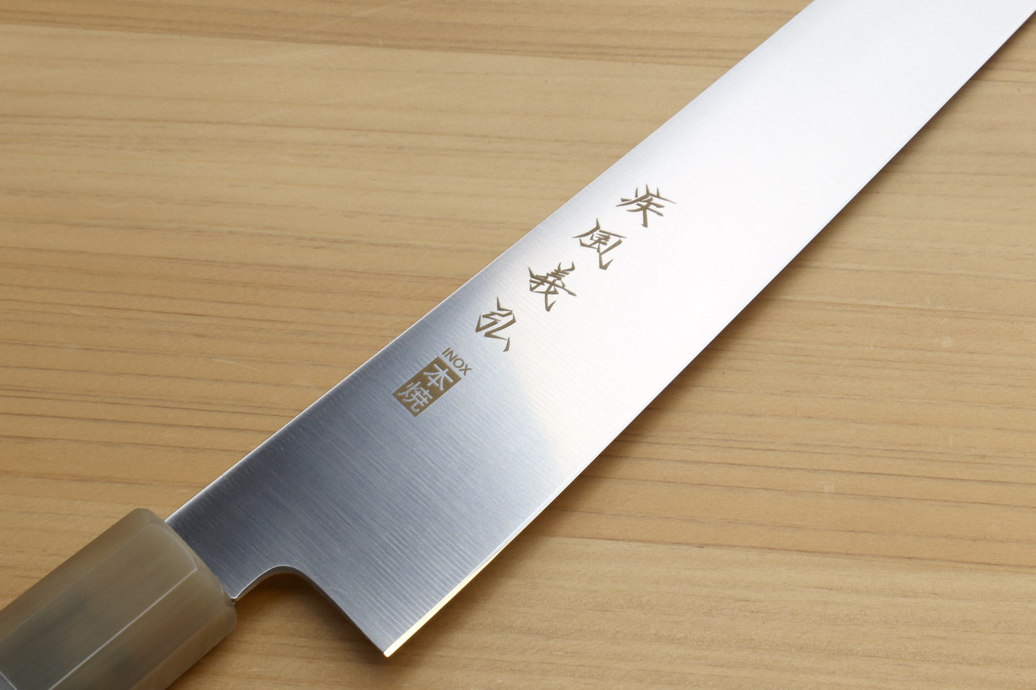 Sujihiki knife blade side view with etched characters