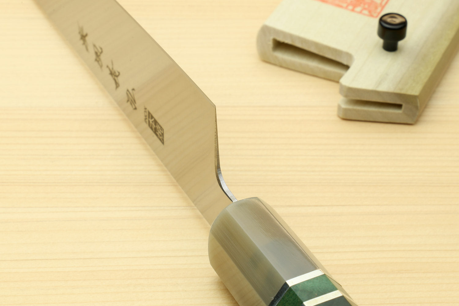 Sujihiki slicer knife blade close-up with dark green handle