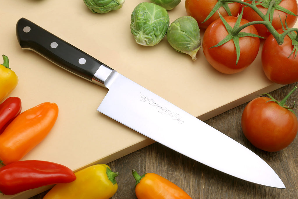 Double-edged deba fillet knife with dark handle and silver blade, angled view